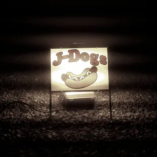 a lit up sign in the dark