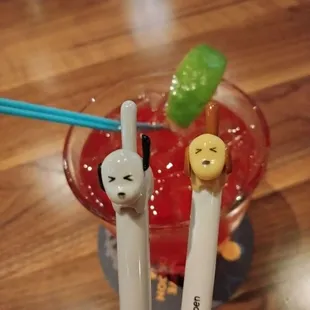 a drink with two chopsticks