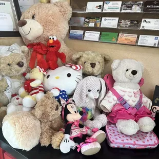 a bunch of stuffed animals on a desk