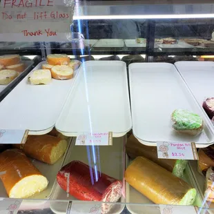 a variety of pastries in a display case