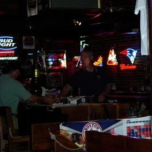 two men sitting at a bar