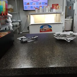 a counter with a tv in the background