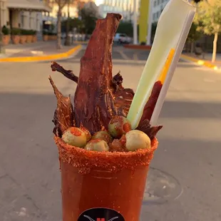 a person holding a cup of food