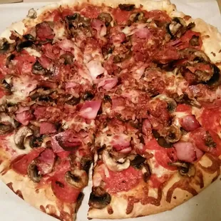 a pizza with mushrooms and ham