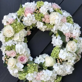 Lush garden wedding wreath.   Fresh hydrangeas, garden roses, and berries.