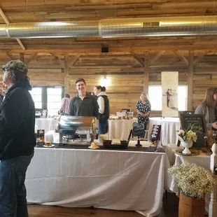 a group of people standing around a buffet table