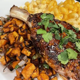 Korean Bbq glazed pork chop with sweet potato home fries and Mac and cheese