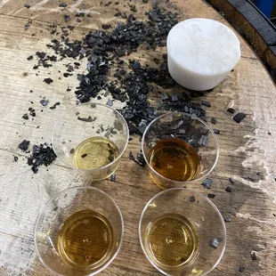 a barrel of whiskey and four glasses of liquor