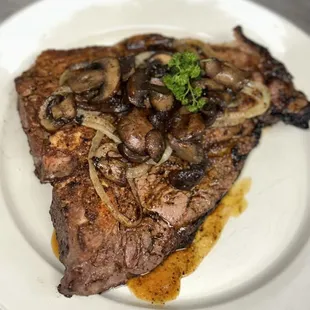 Porterhouse steak with sautéed mushrooms and onions