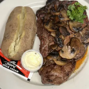 Oswego ribeye with sautéed mushrooms and onions with a baked potato