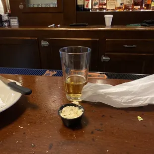 a glass of beer on a bar