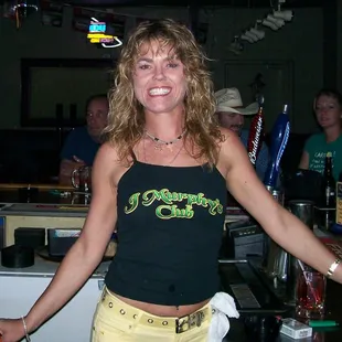 a woman standing at a bar