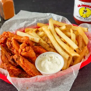  a basket of chicken wings and fries