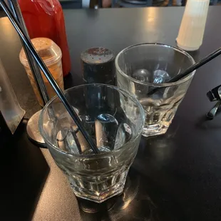 two glasses of water and a spoon