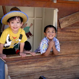 Here is a tiny play house behind the rocking horses.