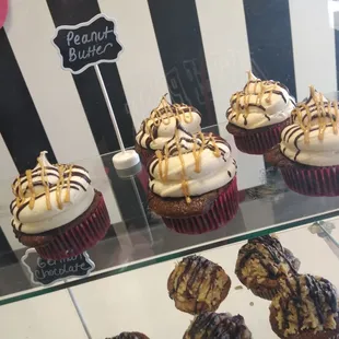 a display of cupcakes in a bakery