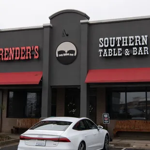 a white car parked in front of the restaurant