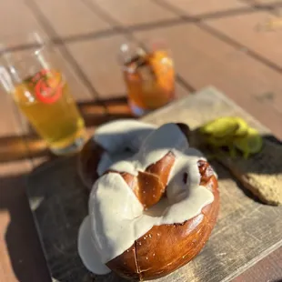 a doughnut with icing and a glass of beer