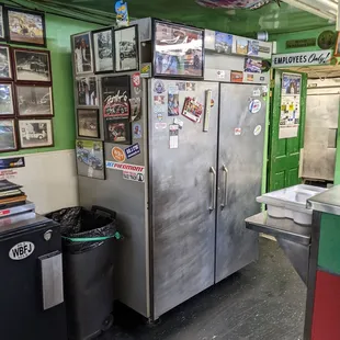 a refrigerator and trash cans
