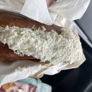 a person holding a sandwich