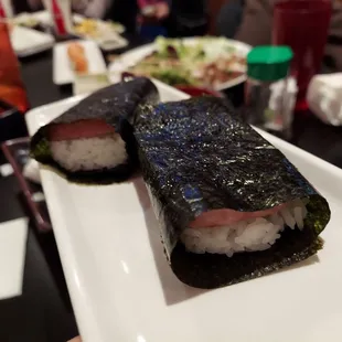two pieces of sushi on a plate