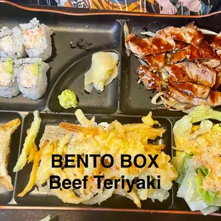 Beef Teriyaki Bento Box Ginger Salad,  1/2 California roll, gyoza, tempura shrimp,  vegetables, and miso soup