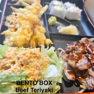 Beef Teriyaki Bento Box Ginger Salad,  1/2 California roll, gyoza, tempura shrimp,  vegetables, and miso soup