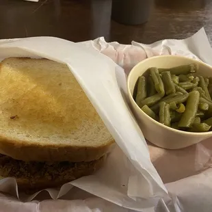 2 meat sandwich with green beans.