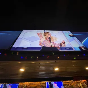 a woman on a large screen