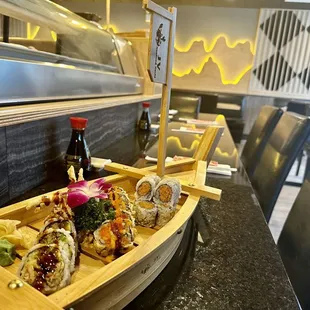 a wooden boat filled with sushi