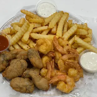 a plate of fried shrimp and fries