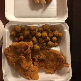 fried fish and beans in a styrofoam container