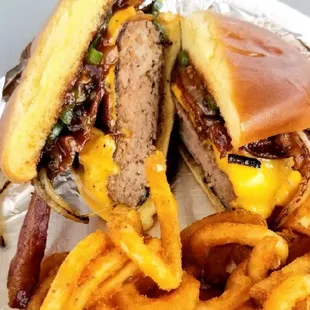 The Rancher - 1/2 lb bacon cheeseburger with sautéed onions,  fried jalapeño, and BBQ sauce. Served with fries and a drink.