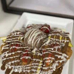 Fried banana pancake topped with a fruits and ice cream