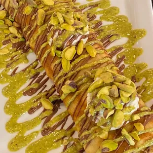 Pistachio crêpes inside and topped with cream cheese
