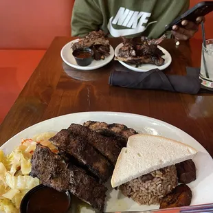 Jerk rib entree with cabbage, rice and peas, plantain, and cocoa bread. Also, jerk rib and jerk lamb chops appetizers