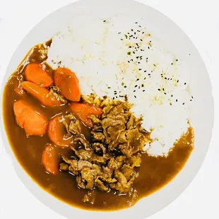 a plate of rice, carrots, and meat