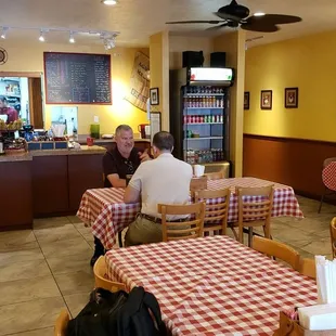 people sitting at tables in a restaurant