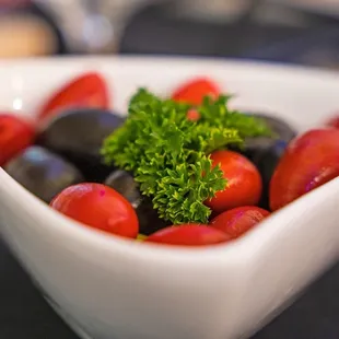 a bowl of olives and tomatoes