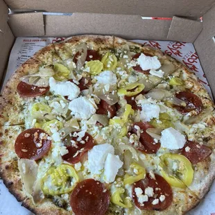 Pesto, pepperoni, mozzarella, feta, ricotta, banana pepper, garlic, &amp; carmelized onion