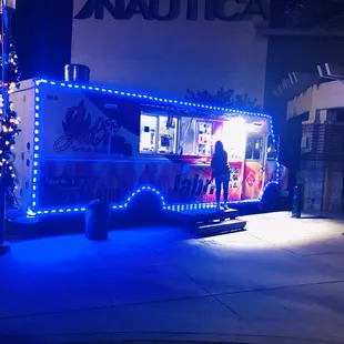 a food truck with blue lights