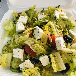 a salad in a styrofoam container