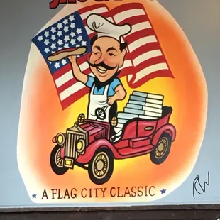 a man driving a car with an american flag