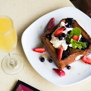 Dee Dee&apos;s Short Stack: Mascarpone stuffed Challah french toast, TX whiskey &amp; local honey glaze, berry compote, Mexican vanilla whipped cream