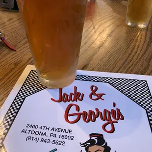 a pint of beer and a menu