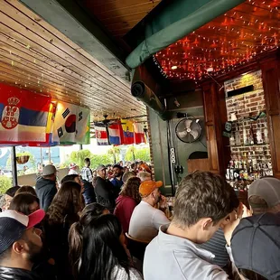 a large group of people sitting at a bar