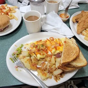 Cheese burger with fries, western omelet with home fries and white toast and chicken tenders with fries.