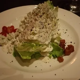 Huuuuuge wedge salad with may tag Bleu cheese and bacon chunks