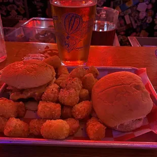 a tray of fried chicken and a beer