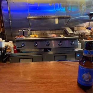 Sitting at the bar watching this guy make the best burgers in town.